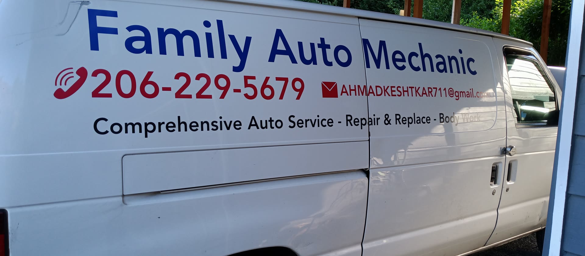 The Family Auto Mechanic service van, painted with the shop's name, phone number, and email